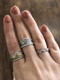 Our original white and yellow gold Teton stacking rings are iconic and customizable! Bring the mountains with you wherever you go. Featured here are our Teton stacks paired with diamond eternity bands. Re-pin if you love the mountains! Ring Stacking Ideas, Delicate Silver Rings, Morganite Diamond Ring, Gold Flower Earrings, Mountain Jewelry, Stacked Wedding Rings, Diamond Stacks, Unique Bands, Sterling Silver Stacking Rings