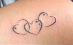 three hearts tattoo on the back of a woman's shoulder