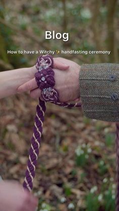 two people holding hands over a purple rope