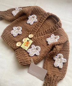 a brown sweater with teddy bears on it and a tag hanging from the neckline