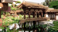 a large building sitting on top of a lake next to a lush green forest covered hillside