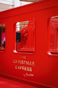 the christmas express train is red and has gold lettering