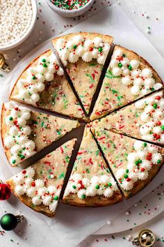 a cake with white frosting and sprinkles on it sitting on top of a table