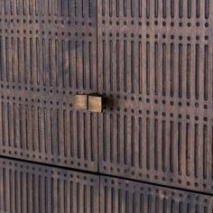 a close up of a wooden door with holes in it