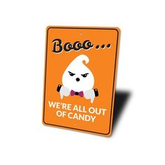 a sign that says boo we're all out of candy on an orange background