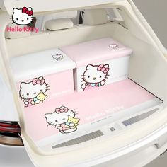 two hello kitty boxes sitting in the trunk of a car