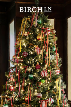 a decorated christmas tree with red, white and green ornaments on it's branches