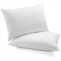 a white pillow sitting on top of a bed