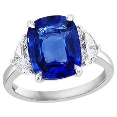 Showcases a Cushion cut, Vibrant color Blue Sapphire weighing 5.12 carats, flanked by two brilliant cut half moon diamonds weighing 0.89 carats total. Elegantly set in a polished platinum composition. Luxury Timeless Hallmarked Sapphire Ring, Modern Sapphire Engagement Ring, Engagement Ring Modern, Golden Rings, Modern Engagement Rings, Pink Sapphire Ring, Engagement Rings Platinum, Golden Ring, Blue Sapphire Diamond