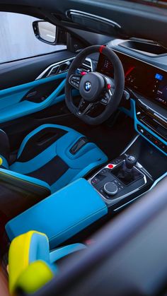 the interior of a car with blue and black leather trims, steering wheel, dashboard, and dash board