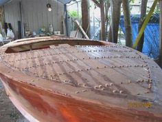 a wooden boat being built in a building