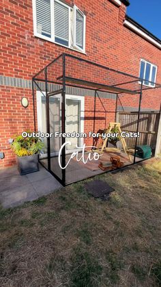 an outdoor enclosure for your cat is shown in front of a brick building