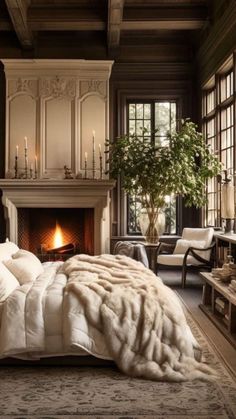 a large bed sitting in a bedroom next to a fireplace with candles on top of it