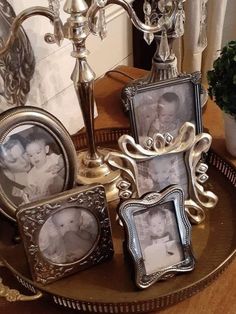 a table topped with three pictures and a candelabra