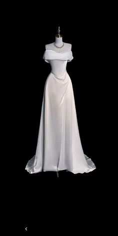 a white dress on display in the dark