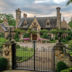 a gated in driveway leading to a large house