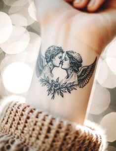 a woman's arm with a tattoo on it that has an angel and a flower