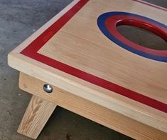 a wooden table with a red, white and blue circle on it's top