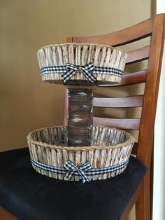 two baskets sitting on top of a wooden chair