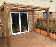 a wooden deck with potted plants on it