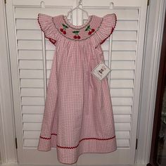 Size 5 Nwt Cherry Bishop Angel Sleeve Dress Pink White Gingham Cute Sleeveless Dress With Smocked Cuffs, Holiday Dresses With Smocked Back, Red Summer Dresses With Smocked Cuffs, Cute Gingham Smocked Dress With Ruffles, Red Summer Dress With Smocked Cuffs, Casual Red Cotton Smocked Dress, Sleeveless Smocked Dress With Smocked Cuffs, Red Cotton Dresses With Smocked Cuffs, Red Cotton Dress With Smocked Bodice