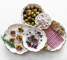 three plates filled with different types of food on top of a white countertop next to each other