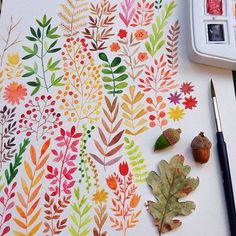 a painting with leaves and acorns on it next to a paintbrush, watercolor