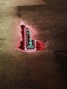 a red fire hydrant sitting on the side of a road next to a sidewalk