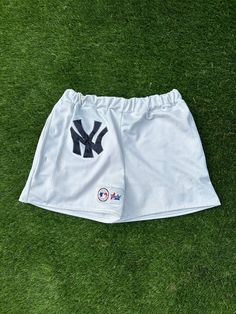 Custom made New York Yankees jersey shorts. Made from a Majestic New York Yankees jersey. Elastic band and two pockets added. Best fits waist sizes 30-36in.  THIS IS A 100% UPCYCLED PRODUCT I am self-taught and NOT a professional. Stitching errors or size issues are likely with a handmade product. If you have any questions or concerns about a product, please message me. Thank you for supporting a creator! Athletic Shorts With Elastic Waistband For Sports, Sporty Shorts With Built-in Shorts For Sports Events, Cotton Athletic Shorts For Sports Events, Summer Sports Shorts With Letter Print, Summer Sports Event Shorts With Letter Print, Letter Print Shorts For Sports Events In Summer, White Athletic Shorts With Letter Print, Casual Sports Bottoms With Pockets, Cotton Bottoms With Built-in Shorts For Sports