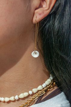 These Puka shell threader earrings exude Hawaii's natural beauty. These long gold earrings feature natural puka shells dangling from 14kt gold filled threaders. A Hawaii staple. They are perfect solo or teamed with our other earrings.✦ DETAILS ✦✧ Name: Auali'i - (AOO a LEE ee) - Noble, royal.✧ 14kt Gold Filled w/ natural Puka shells.✧ 2.25in Drop Length.✧ All Ke Aloha Jewelry pieces come packaged thoughtfully, beautifully, and ready for gift giving. Hawaiian Shell Jewelry, 14k Gold-filled White Linear Long Drop Earrings, White 14k Gold Filled Long Drop Linear Earrings, Everyday White Threader Earrings, White Dangle Threader Earrings For Everyday, White Dainty 14k Gold Filled Threader Earrings, White 14k Gold Filled Dainty Threader Earrings, Dainty White 14k Gold Filled Threader Earrings, Hawaii Jewelry