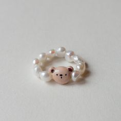 Adorn yourself with an elegant but mainly playful pearl ring made of genuine river pearls and hand-modelled pendant. 
The bear charm is hand made from polymer clay, then painted and varnished.
The bead is of course personalizable! If you would like the same type of bracelet but with a different bead, just drop me a line :) Playful White Jewelry For Birthday, Handmade Polymer Clay Kawaii Jewelry, Handmade Kawaii Polymer Clay Jewelry, Handmade White Kawaii Jewelry, Cute Personalized Polymer Clay Jewelry, White Handmade Kawaii Jewelry, White Kawaii Polymer Clay Jewelry, Kawaii White Jewelry For Gifts, Novelty White Hypoallergenic Jewelry