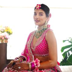 a woman in a pink dress sitting down