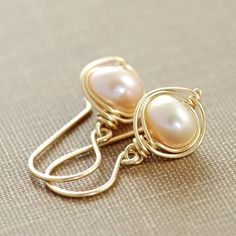 Delicate and beautiful. Elegant Yellow Gold Pearl Earrings With Ear Wire, Delicate Pearl Earrings Wire Wrapped, Classic 14k Gold Pearl Earrings With Ear Wire, Elegant Yellow Gold Wire Wrapped Pearl Earrings, Elegant Wire-wrapped Yellow Gold Pearl Earrings, June Birthstone Jewelry, Pearl Earrings Dangle, Wire Earrings, Pearl Studs