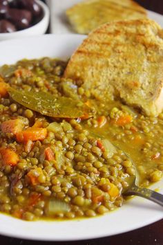 a white plate topped with beans and bread