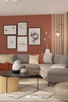 a living room with orange walls and grey furniture