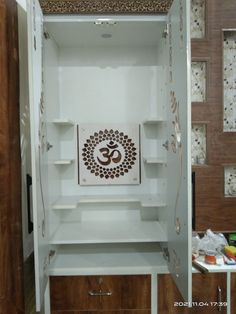 the inside of a white cabinet with an omesh symbol painted on it