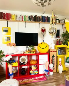 a living room filled with furniture and a flat screen tv mounted on a wall next to a book shelf