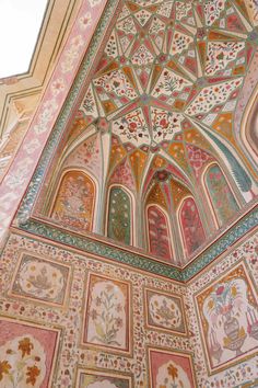 an intricately painted ceiling in the middle of a room with many different colors and designs