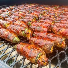 several skewered meats are being cooked on a grill