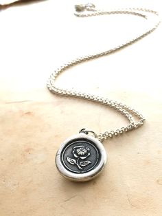 "This English Rose wax seal pendant is handmade made using a vintage Wax Seal from the early 1900's (Art Deco era). The rose symbolizes beauty, love, purity and passion and is also the symbol of motherhood. This necklace makes a meaningful heartfelt gift, it will arrive beautifully packaged and ready for gifting. D E T A I L S: * 925 Sterling Silver * Wax Seal Pendant is 3/4\" wide * Select from several 925 sterling silver chain styles or choose just the charm at checkout * Handmade in the USA N Vintage Rose Design Necklaces For Valentine's Day, Classic Rose Design Jewelry For Gifts, Vintage Rose Necklace For Gift, Vintage Rose Color Necklace For Gift, Rose Vintage Necklace For Gift, Vintage Rose Design Jewelry As A Gift, Vintage Jewelry With Rose Design Flower Pendant, Vintage Silver Necklaces With Rose Design, Vintage Silver Necklace With Rose Design