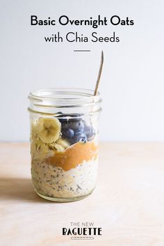 a glass jar filled with fruit and oatmeal on top of a wooden table