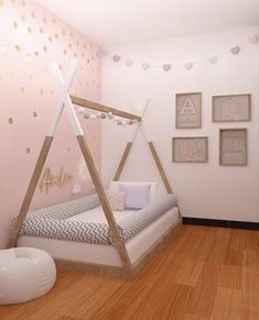 a bedroom with pink walls and wooden floors