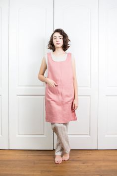 "SIZING AND FIT The linen apron is of a regular fit - we recommend choosing the size you usually wear. Before placing on order check our size chart below. Model in picture is 168cm / 5'6\" and is wearing size S. SIZE XS Bust: around 33.5\" / 85cm Waist: around 26\" / 66cm Hips: around 36\" / 91 cm SIZE S Bust: around 35.5\" / 90 cm Waist: around 28\"/ 71 cm Hips: around 38\"/ 97 cm SIZE M Bust: around 37.5\" / 95 cm Waist: around 30\"/ 76 cm Hips: around 40\"/ 102 cm SIZE L Bust: around 40\"/ 10 Pinafore Apron Dress, Linen Pinafore Apron, Japanese Apron, Linen Pinafore, Salmon Pink Color, Pinafore Apron, Apron Dress, Linen Apron, Etsy Fashion