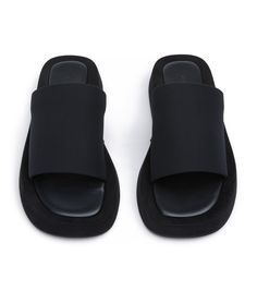 We know you love effortless style. Cue our Isabel slides in classic black. Featuring an elevated platform foot bed, with simple fabric strap design, they're the perfect Summer sandal for the minimalist. - Material: Fabric upper and rubber lining - Toe-shape: Round toe shape - Pattern: Fabric strap - Fit: Runs true to size - Heel Height: 1.5cm Black Slip-on Slide Mules, Black Platform Slides For Summer, Comfortable Black Platform Slide Slippers, Comfortable Black Platform Slippers With Textured Footbed, Black Textured Slip-on Platform Slippers, Black Slide Platform Slippers For Spring, Modern Black Platform Slippers With Textured Sole, Comfortable Black Leather Platform Slippers, Black Synthetic Platform Slide Slippers