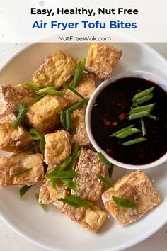 fried tofu bites on a white plate with sauce and green beans in the bowl