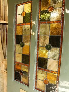 two stained glass doors with handles on them