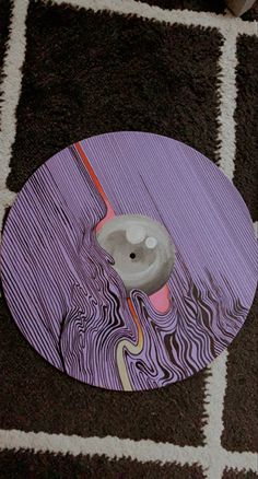 a close up of a skateboard on a carpeted floor with white and black squares