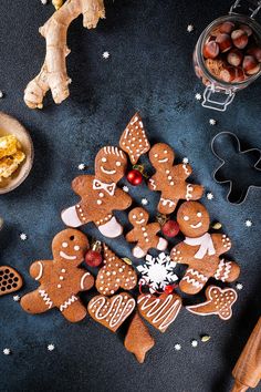 gingerbread cutouts arranged in the shape of christmas trees and snowflakes on a table