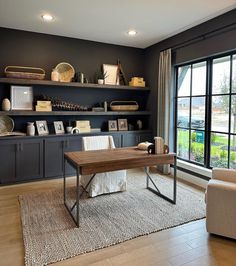 a living room filled with furniture next to a large window covered in lots of windows