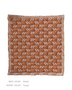 an orange and white knitted square on a white background